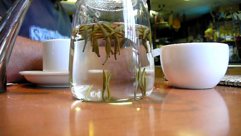 Brewing Baihao Yinzhen with a glass teacup
