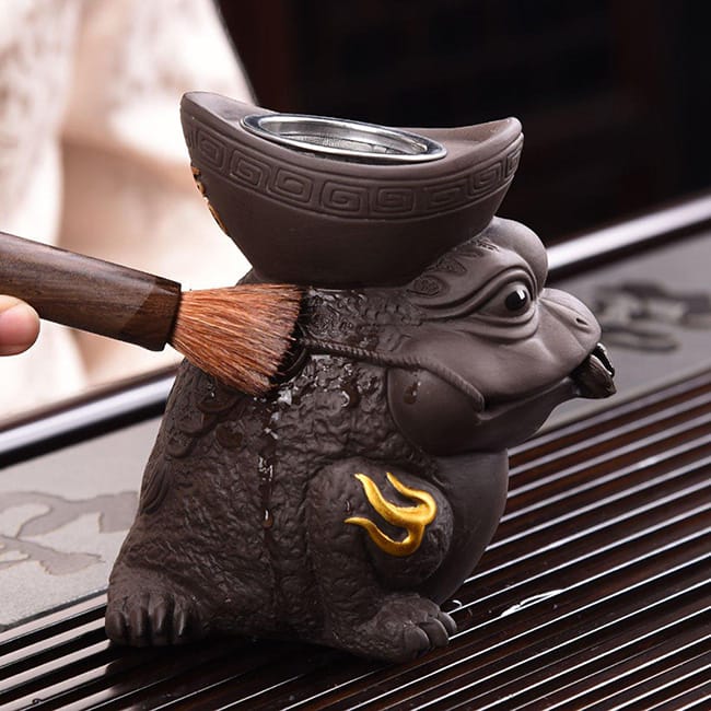 Scrubbing the tea pet with a brush gently