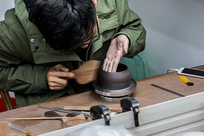A master ceramist making a Zisha teapot with handmade